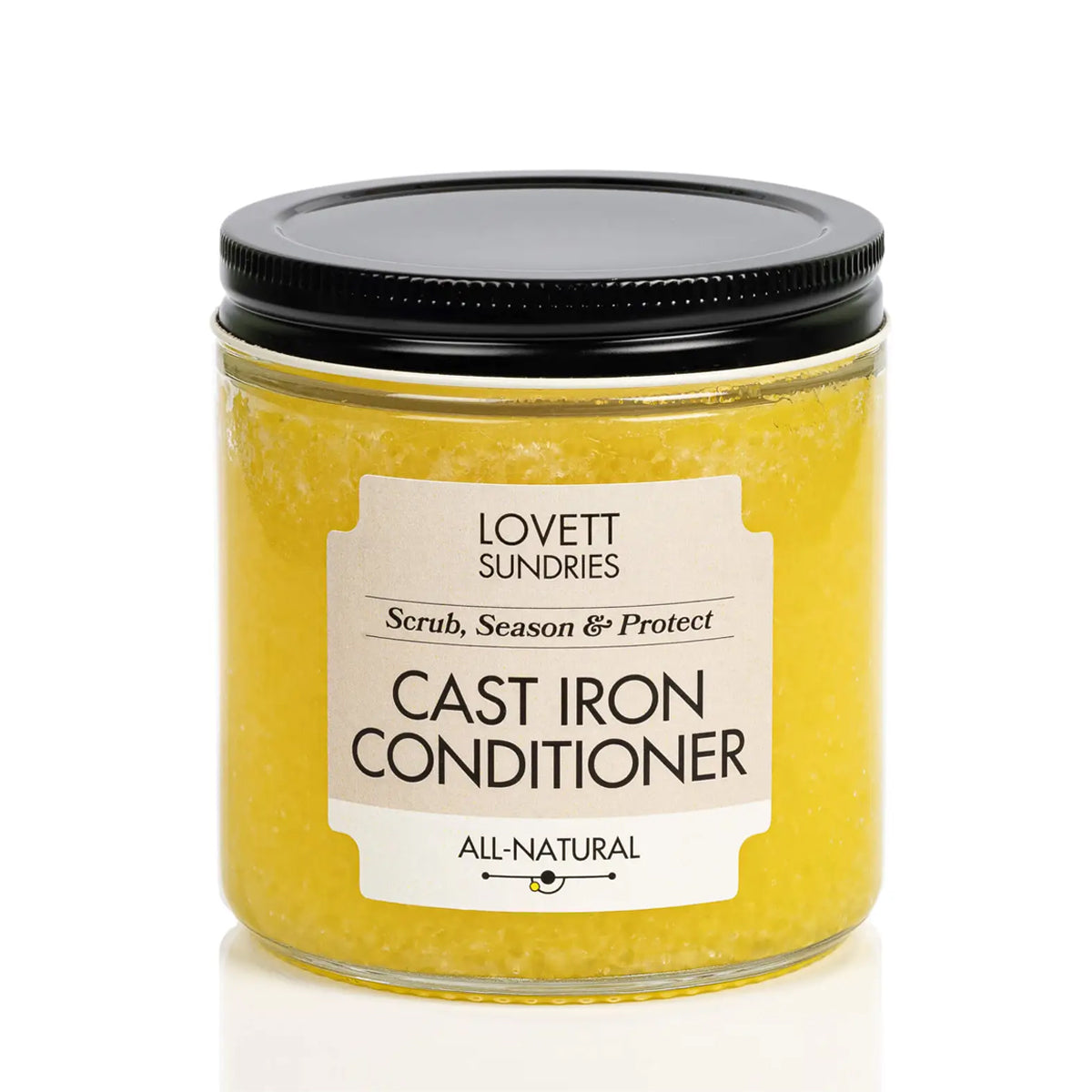 A glass jar with a black lid filled with a yellow substance. A label on the front reads "Lovett Sundries" and "Cast Iron Conditioner".