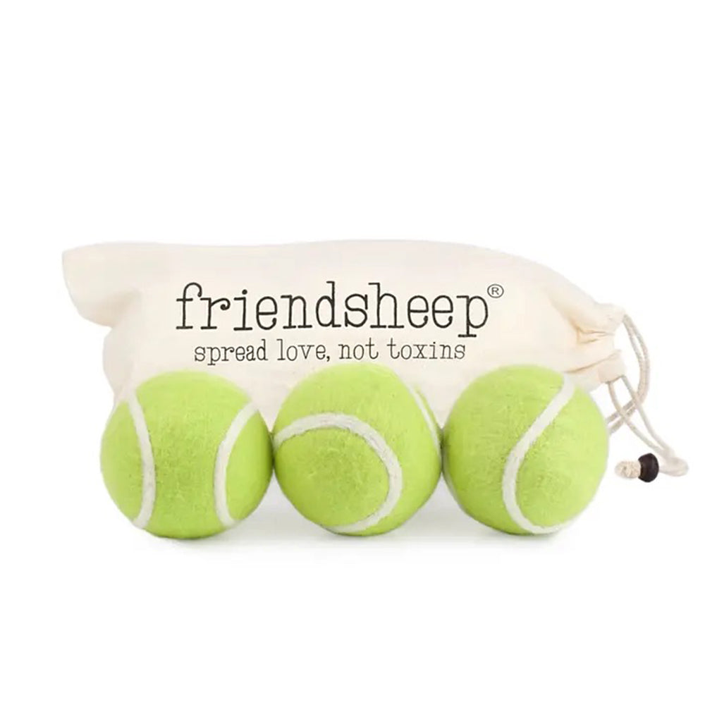 Three green tennis balls with white strings in a drawstring bag, branded 'friendsheep'.