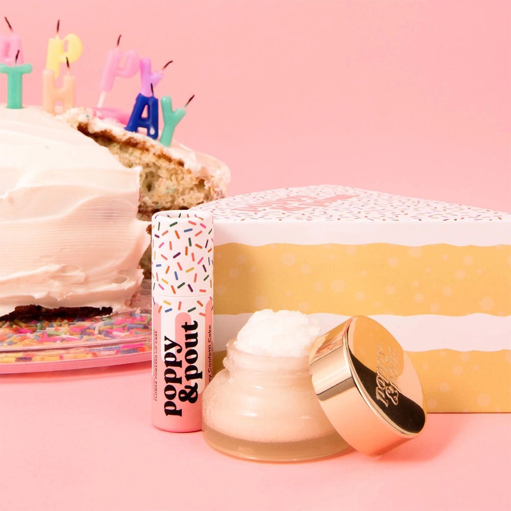 Cosmetic product with 'Poppy & Point' branding on a pink background with a cake and candles.