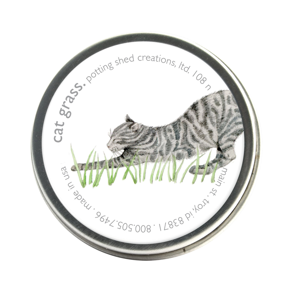 A silver tin of garden sprinkles with a white label on the lid. The label features a watercolor illustration of a gray tabby cat stretching low in green grass, with the text 'cat grass, potting shed creations' around the edge.