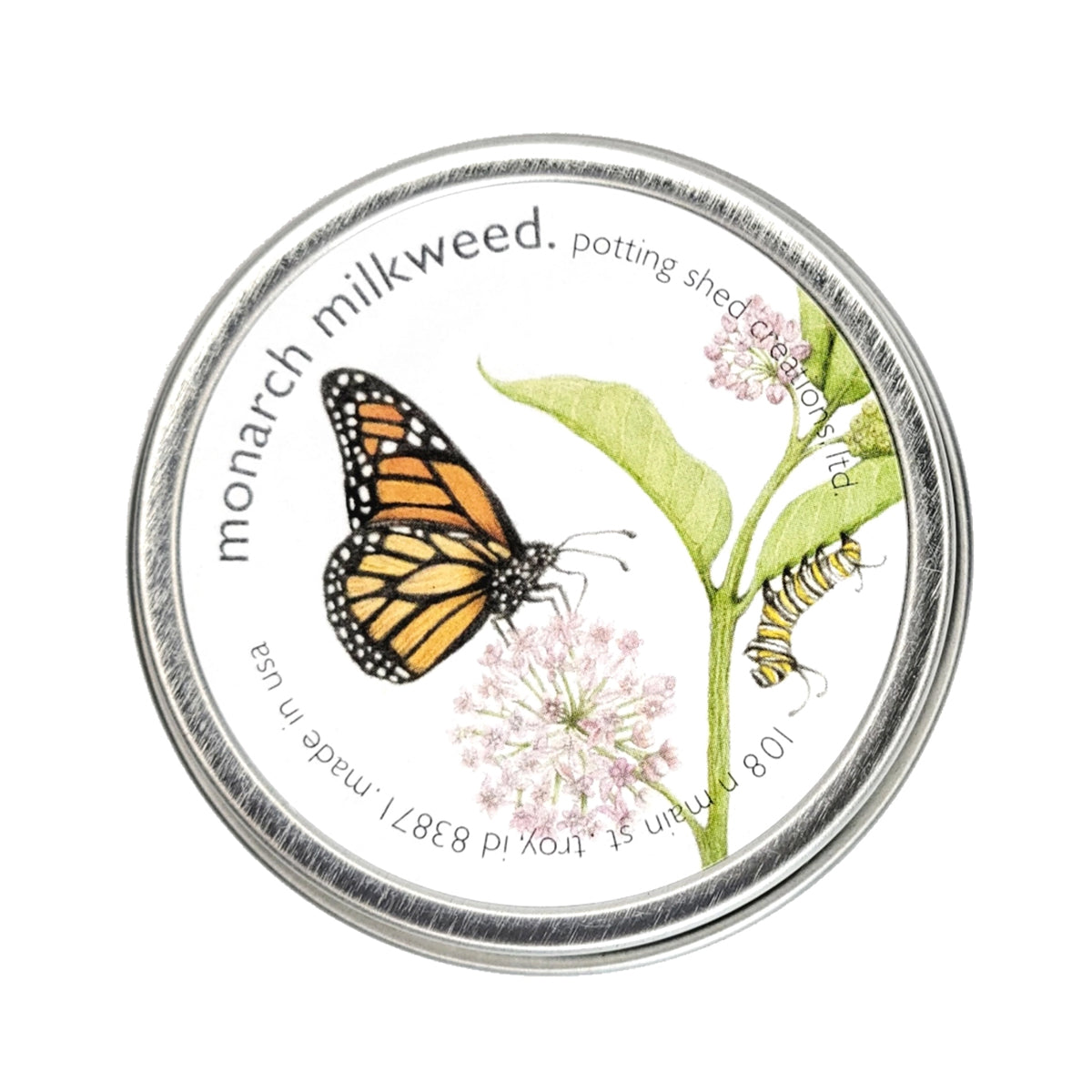 A silver tin of garden sprinkles with a white label on the lid. The label features a watercolor illustration of a monarch butterfly and a caterpillar on a pink milkweed flower, with text reading 'monarch milkweed, potting shed creations'.