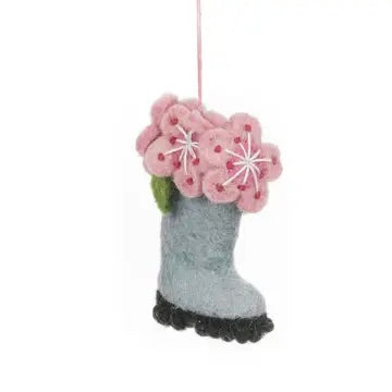 A handmade felt hanging ornament of a gray boot with a black sole is shown. Pink flowers with white centers are blooming from the top of the boot.