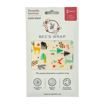 Packaging for Bee’s Wrap reusable food wraps showing a hexagonal window with a fun nature-themed pattern and fresh vegetables inside the wrap.