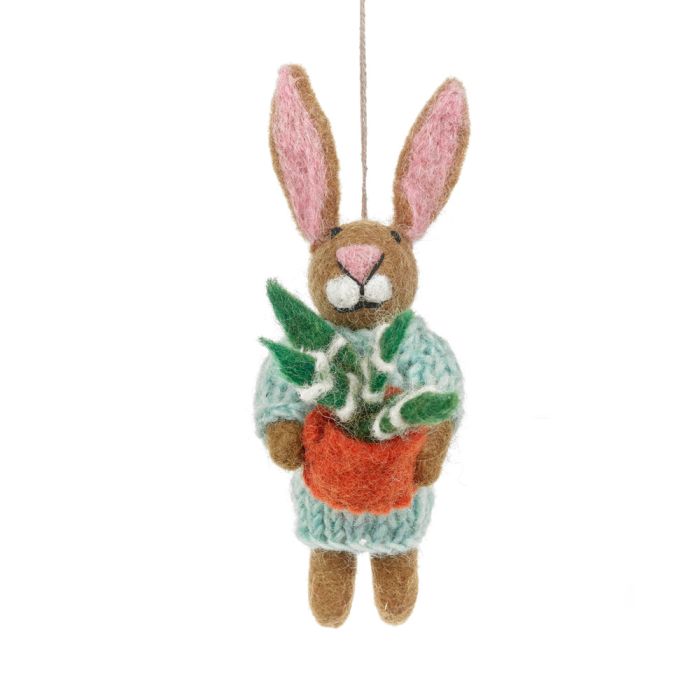A handmade felt rabbit hanging ornament is shown, dressed in a light blue sweater. It has brown and pink ears and is holding an orange pot with a green plant inside.